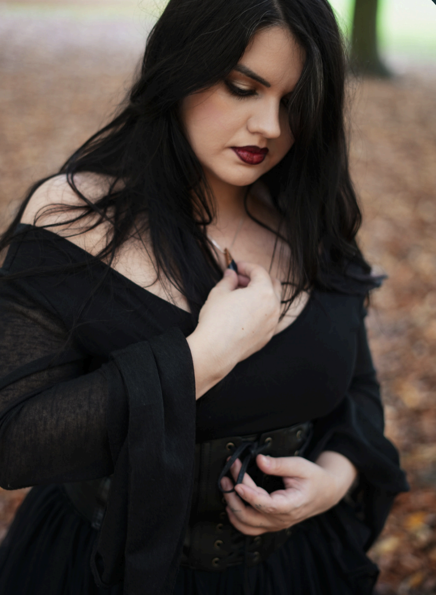 The Image Consultant Francesca Moon is wearing a beautiful black dress and elegant makeup.